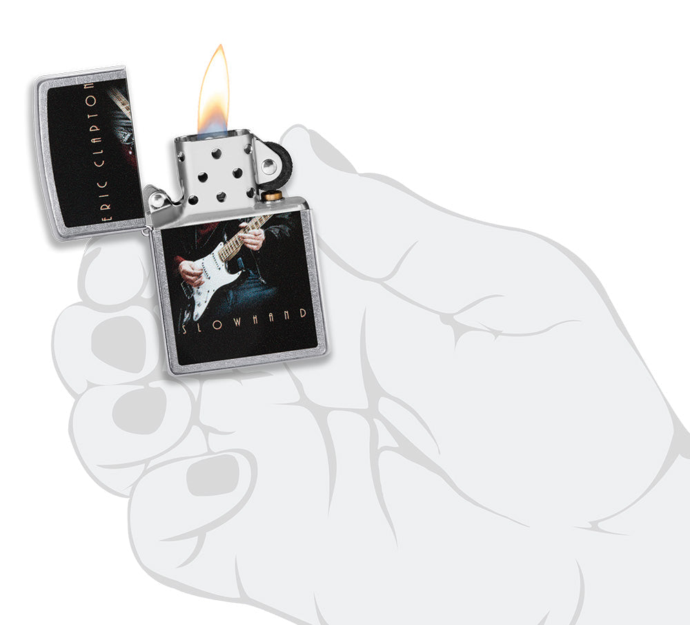 Zippo lighter front view chrome open and lit with coloured image of Eric Clapton playing guitar in stylistic hand