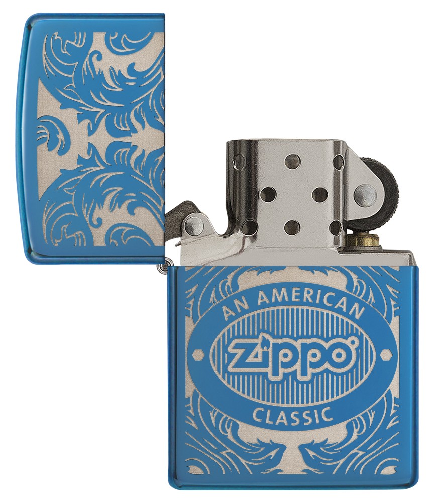 Blue Zippo lighter open front view without flame surrounded by a laser-engraved filigree motif showing the Zippo logo and "an american classic".